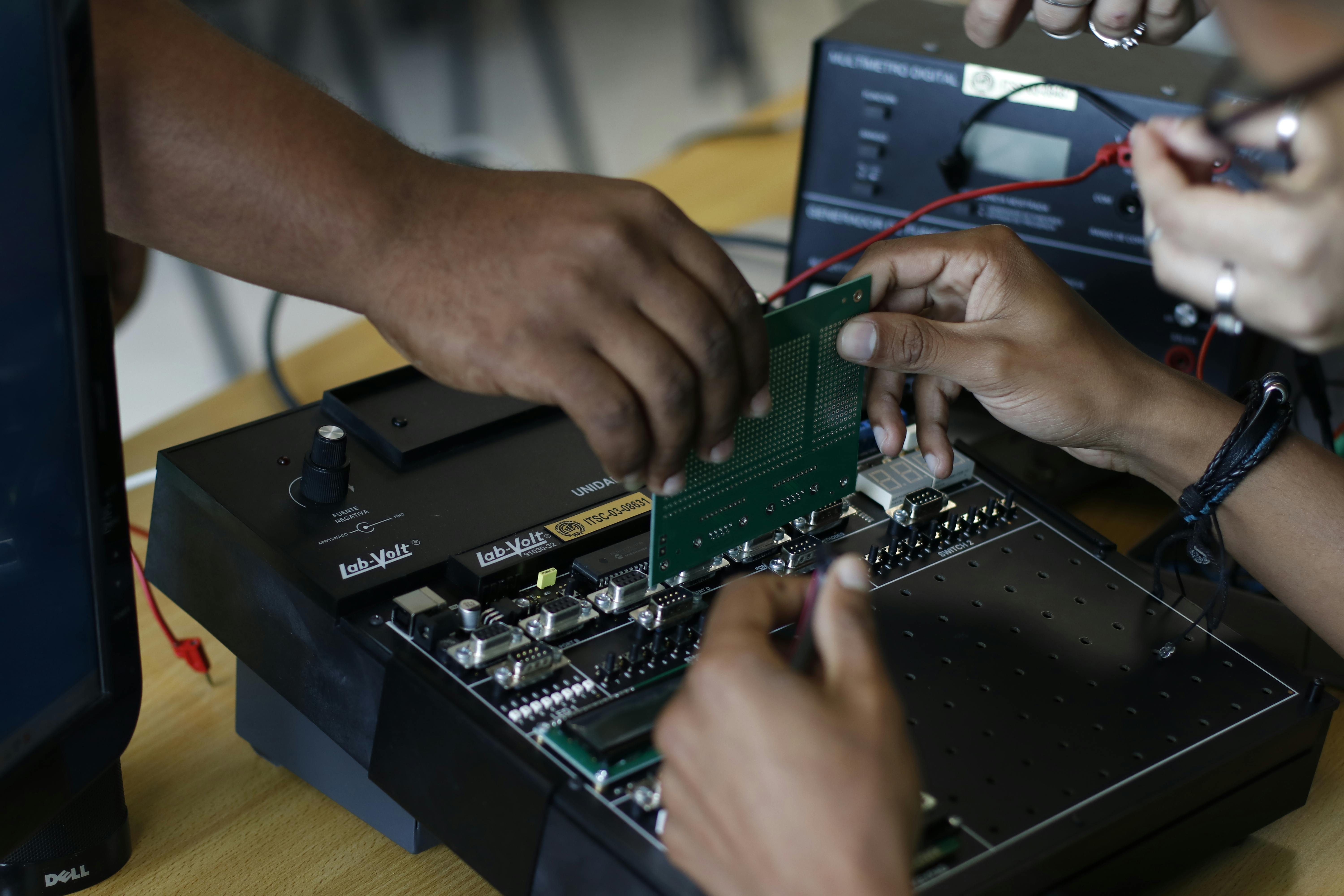 Learners working with electronics in a lab